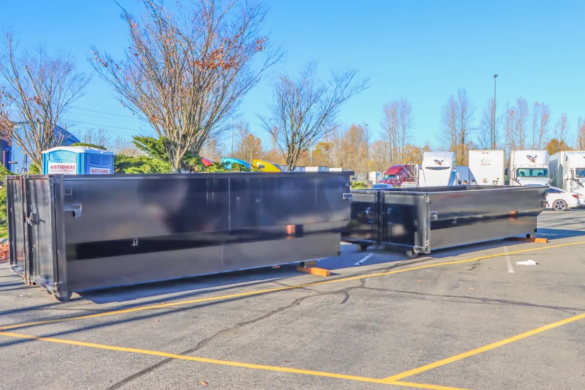 Professional dumpster rental service with roll-off container on residential driveway in South Amboy